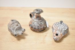 An antiquity pottery vessel of baluster form, having shaped handle and black glaze, h8.5cm, sold