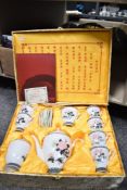 A 20th century Chinese Hongguanyao porcelain tea service in a silk upholstered box, comprising of