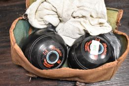 A pair of Hemselite high density bowling balls with carry bag, (2)