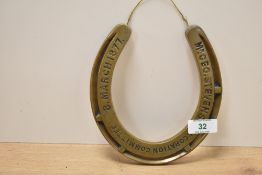 A brass horse shoe having impressed mark for Mr Geo, Stevens Decoration Committee 8, March 1877,