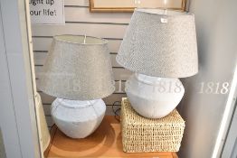 A pair of stone effect table lamps of lobed form, h60cm