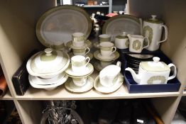 A Royal Doulton fine bone china dinner service, decorated with gilt edging and floral patterns on an