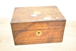 An ornate walnut vanity box, measuring 25cm x 17cm x 13cm, no key present.