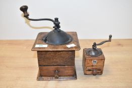 A 20th century wooden coffee grinder having shaped metal handle, h12.5cm, sold together with another