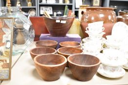 A vintage wooden salad bowl sold alongside a set of six smaller bowls of similar design.