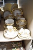 A Japanese Meito pattern part tea service, hand coloured with gilt floral patterns on a white