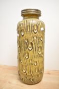 A large West German pottery vase, of cylindrical form with short moulded neck and rim, the body