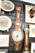 A late 19th century banjo barometer having convex mirror, temperature gauge and decorated with