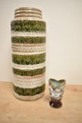 A West German pottery vase, of cylindrical form decorated with bands of moulded and alternating