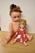 Two Dolls, 1960's Hong Kong Penny Brite Doll wearing red and white dress and a Made in England