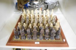 Modern Resin Chess Pieces in the Medieval style, damaged and repairs seen on a modern Chess Board,