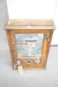A 1950s Wondermatics Allwin penny slot machine, 'Win and Place' pin ball machine in oak case, 75cm x
