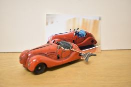 A Schuco clockwork and tin plate Examico 4001 Car in red, key present