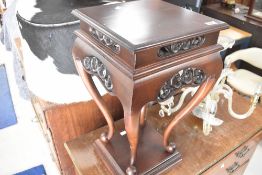 A reproduction hardwood low plant stand, height 63cm