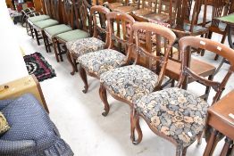 A set of four Victorian mahogany railback dining chairs having vintage moquette style floral seats