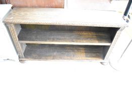 An early 20th Century oak low bookcase having carved decoration , width approx. 132cm