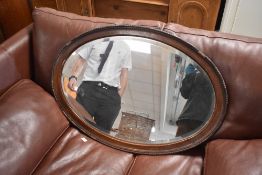 An early 20th Century mahogany framed oval wall mirror, width approx 78cm