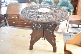 An Eastern style carved occasional table