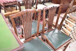 Three early 20th Century mahogany feather back dining chairs