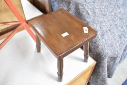 A traditional mahogany stool having four turned legs, approx. 25 x 20cm