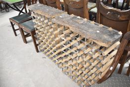Two 48 bottle wine racks having rustic wood tops