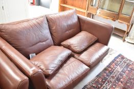 A modern leather two seater settee, by Multi York
