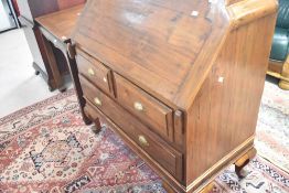 An Oriental teak bureau , the flap having campaign style handles, width approx. 100cm