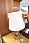 A modern brass effect table lamp