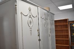 A white finished Olympus continental style triple wardrobe