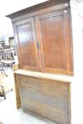 A late 19th or early 20th Century oak cupboard on matched drawer base, width approx. 113cm