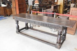 A traditional oak refectory style dining table , having period base and later plank top, approx. 254