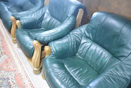 A wood and green leather three piece suite