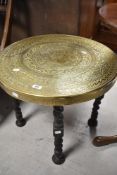 A vintage Eastern style brass circular occasional/coffee table on twist oak frame, diameter