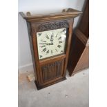 A reproduction oak wall clock, height approx. 82cm