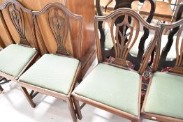 A set of four early 20th Century mahogany framed dining chairs having wheat sheaf style splat