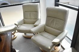 A Stressless armchair and footstool, in cream having light base, in very clean condition