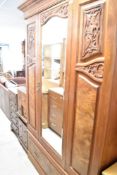 A Victorian mahogany and walnut mirror door wardrobe