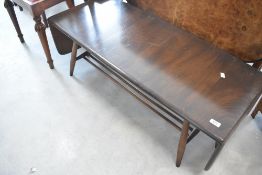 A dark stained Ercol coffee table having drop flaps and undershelf, width approx. 106cm