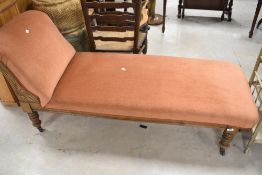 A Victorian chaise longue having mahogany frame and later orange dralon upholstery