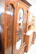 A Victorian mahogany three piece bedroom suite , comprising mirror door wardrobe, dressing table and