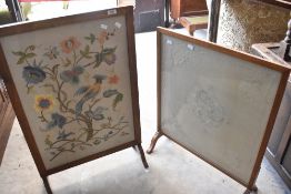 Two vintage golden oak firescreens having embroidered panels