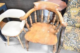 A traditional spindle back elbow chair