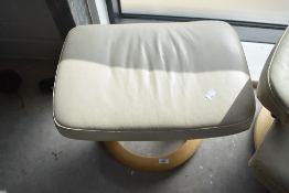 A Stressless armchair and footstool, in cream having light base, in very clean condition