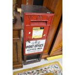 A Victorian postbox having George VI enamelled sign to front, mounted on wood frame