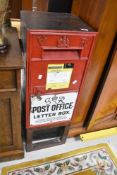A Victorian postbox having George VI enamelled sign to front, mounted on wood frame