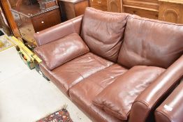A modern leather two seater settee, by Multi York