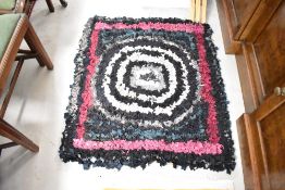 A traditional pegged rag rug, approx 95 x 86cm