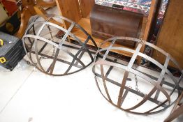 A pair of metal wall hay racks