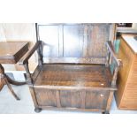 An early 20th Century oak monks bench, width approx. 107cm