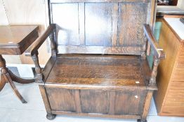 An early 20th Century oak monks bench, width approx. 107cm
